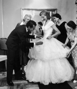 Beatrice Lodge is fitted in a debutante dress by fashion designer Oscar de la Renta in 1956.
